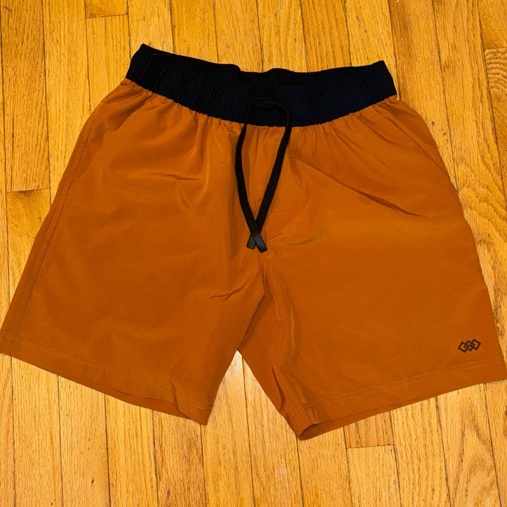 Burnt orange athletic shirt with black waist band